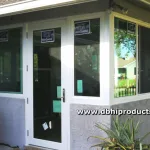 Screened porch conversion to a sunroom using impact windows and a glass entry door by db Home Improvements.