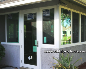 Screened porch conversion to a sunroom using impact windows and a glass entry door by db Home Improvements.