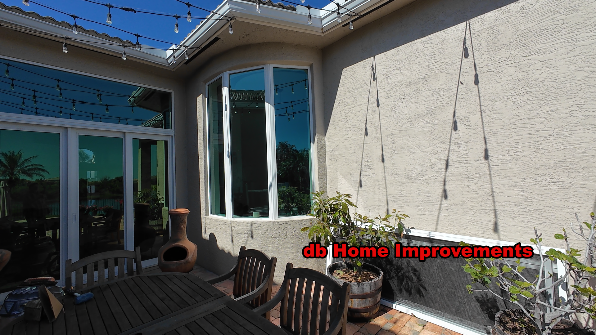 V Premium impact glass sliding doors and custom curved window with Low-E installation on a Palm City Florida home.